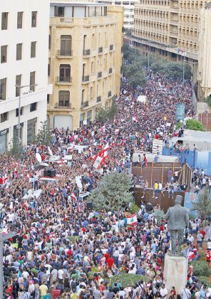 People wave Lebanese flags as they protest against corruption and against the government's failure to resolve a crisis over rubbish disposal, near the government palace in Beirut, Lebanon August 23, 2015. Lebanese security forces fired water cannon at protesters demonstrating against the government near Prime Minister Tammam Salam's offices in Beirut on Sunday, live television pictures showed. REUTERS