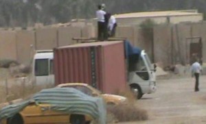 2.Agents photographing and filming Camp Liberty and throwing stones from atop police containers. 2015-09-10