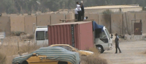 3. Agents photographing and filming Camp Liberty and throwing stones from atop police containers. 2015-09-10